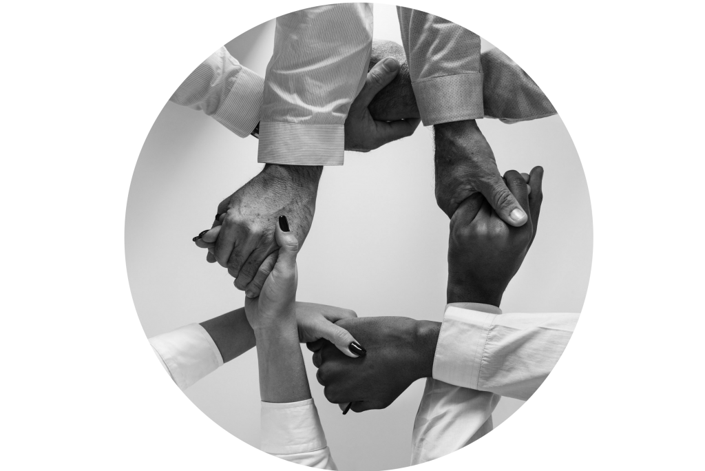 Group of people holding hads in a circle